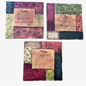 Three wall hangings, faith, hope and love.